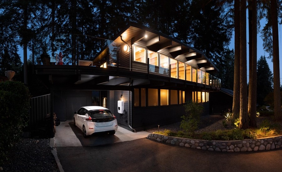 A home illuminated by indoor lights at night.