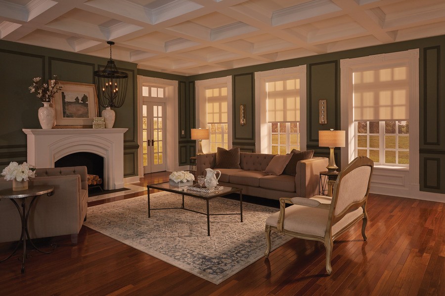 A warm and inviting living room with Lutron motorized shades covering the windows.