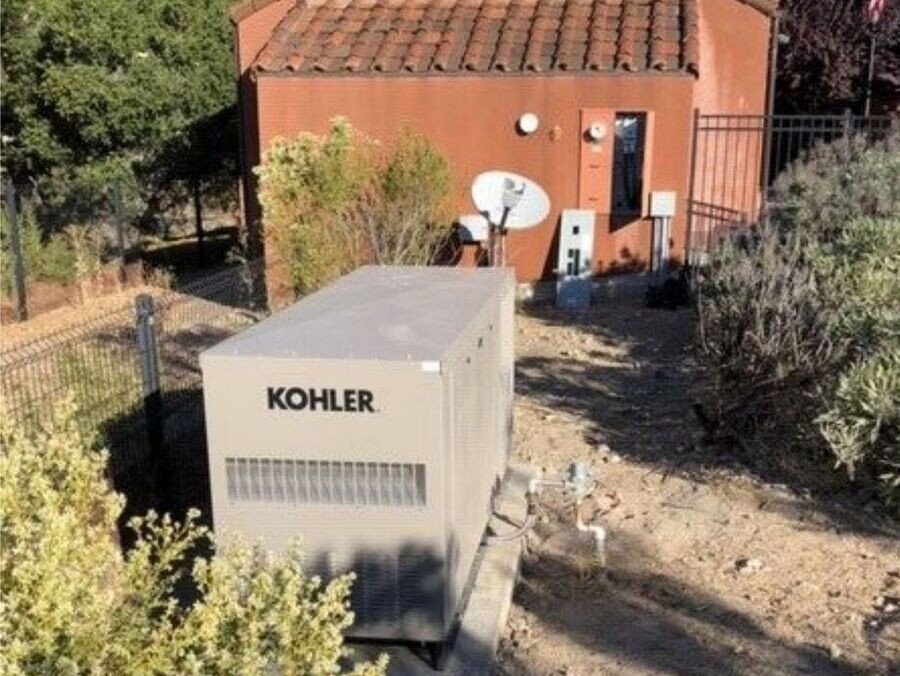 A Kohler backup generator in a backyard.