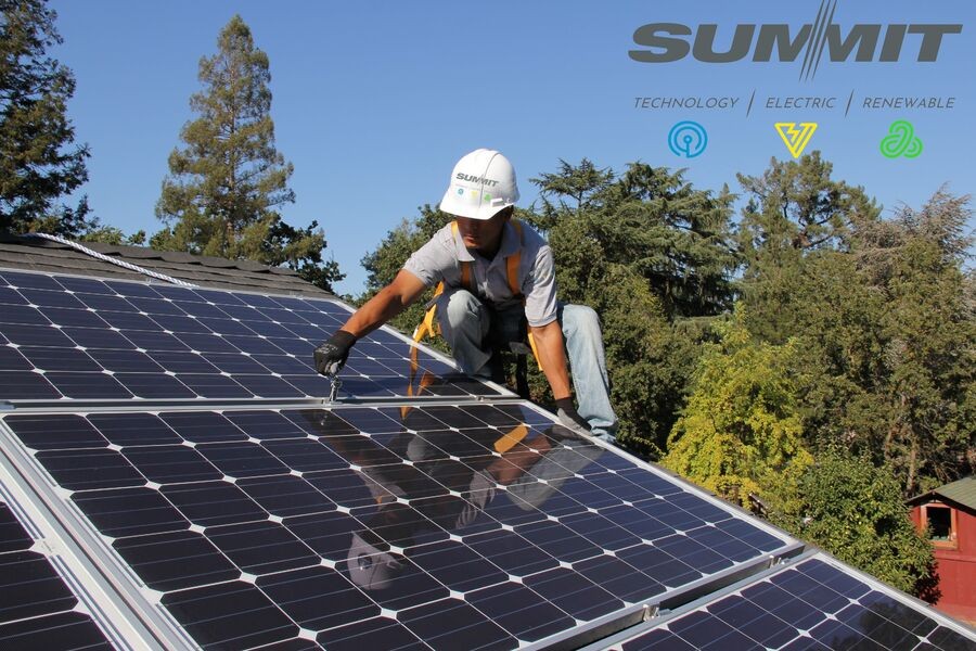 A Summit Technology Group technician installs a solar panel on a roof.