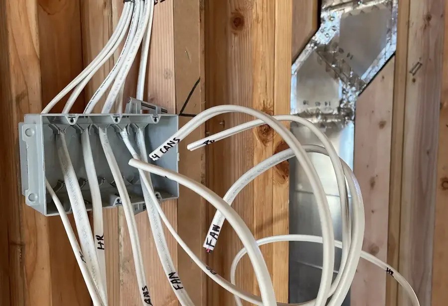 A group of wires inside the walls of a house.