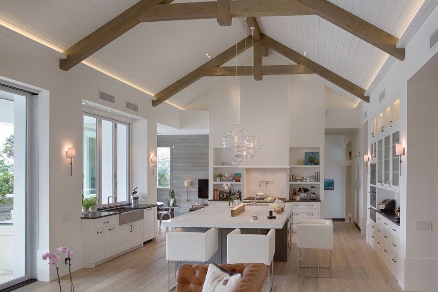 A luxury dining room with a modern interior design and architectural lighting in the ceiling.