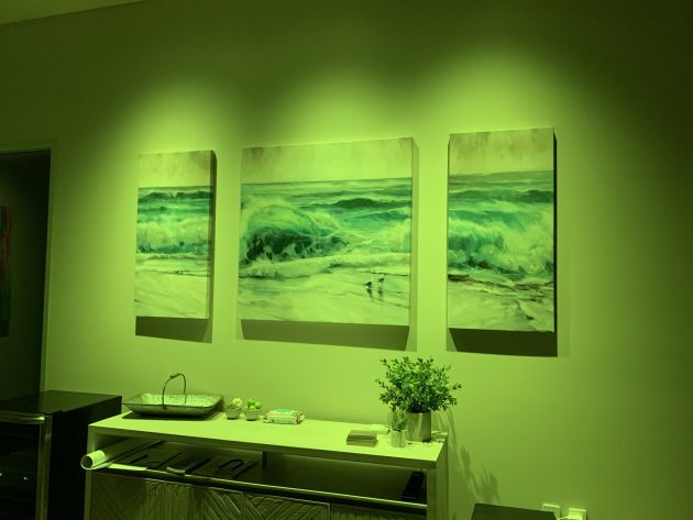 An interior view of a modern room set up for home theater enjoyment, showcasing a large screen, integrated audio equipment, and contemporary furniture arranged for a premium viewing experience.