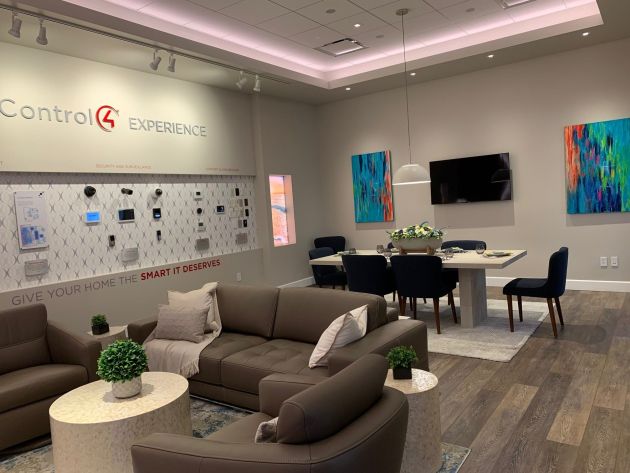 A close-up of a curated collection of modern paintings hanging on a showroom wall, showcasing vibrant colors and contemporary art in an elegant display.