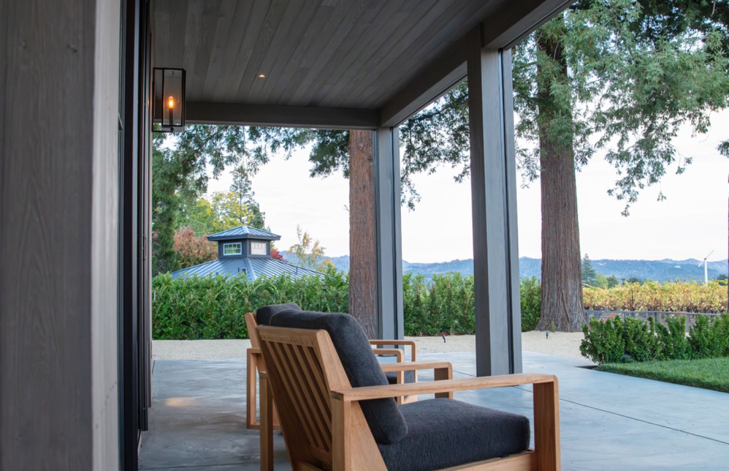 A sleek home theater setup with a large flat-screen display, integrated audio components, and minimalist seating arranged in a dark, ambient room.