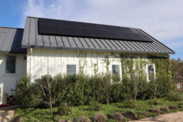 Roof of a home with a solar battery backup and solar panel installation.