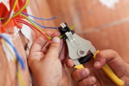 An electrician providing electrical rewiring services.